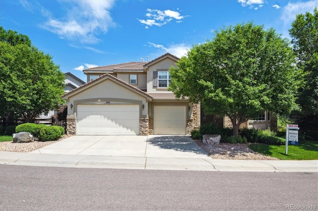 11911 E Lake Cir, Greenwood Village, CO 80111 - view of front of house with stone siding, stucco siding, driveway, and a tiled roof