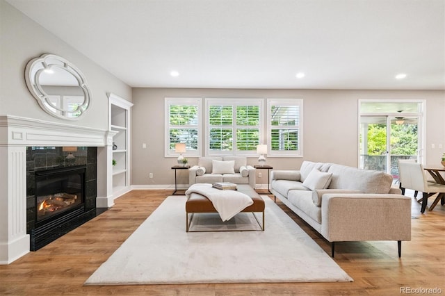 11911 E Lake Cir, Greenwood Village, CO 80111 - living room with plenty of natural light, recessed lighting, wood finished floors, a fireplace, and built in features