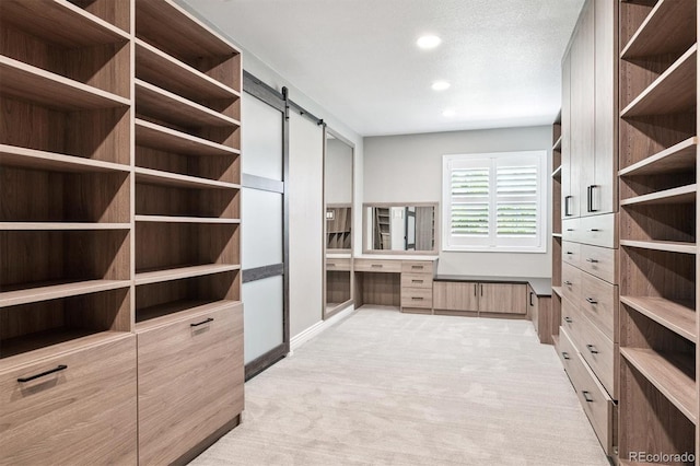 11911 E Lake Cir, Greenwood Village, CO 80111 - spacious closet with a barn door, light colored carpet, and built in desk