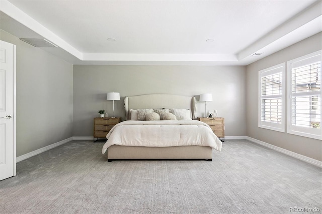 11911 E Lake Cir, Greenwood Village, CO 80111 - carpeted bedroom featuring a raised ceiling and baseboards