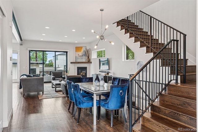 1373 S Garfield St, Denver, CO 80210 - dining space featuring a glass covered fireplace, stairs, wood finished floors, recessed lighting, and a chandelier