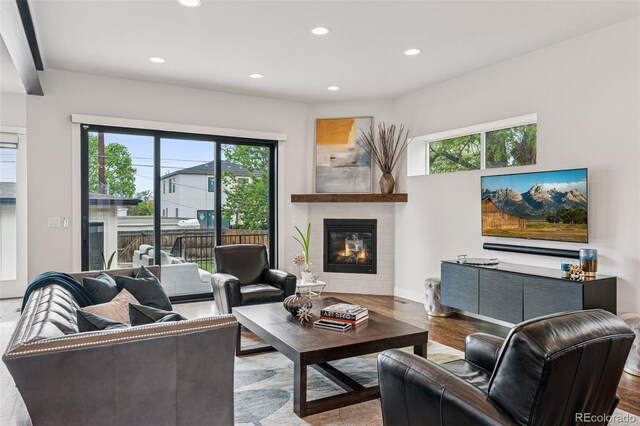 1373 S Garfield St, Denver, CO 80210 - living room with recessed lighting, a glass covered fireplace, wood finished floors, and baseboards