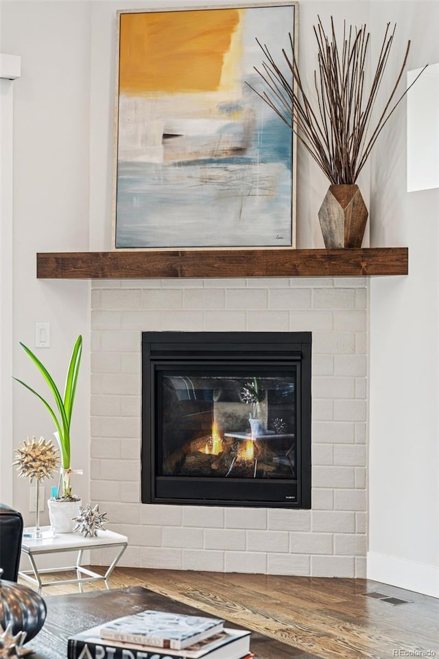 1373 S Garfield St, Denver, CO 80210 - detailed view of wood finished floors, baseboards, and a glass covered fireplace
