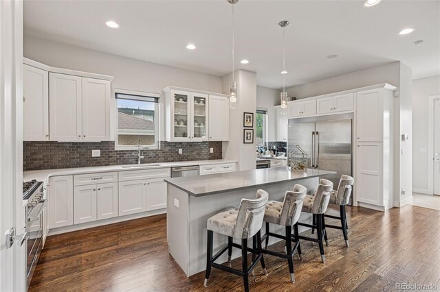 1373 S Garfield St, Denver, CO 80210 - kitchen with a sink, white cabinetry, decorative backsplash, recessed lighting, and dark wood-style floors