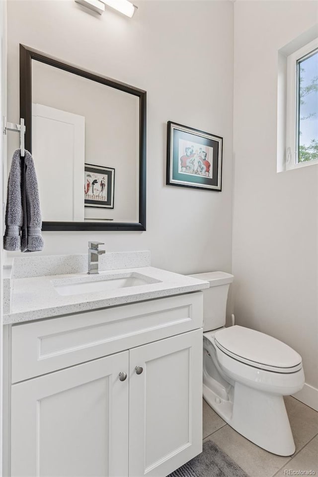 1373 S Garfield St, Denver, CO 80210 - half bathroom with toilet, vanity, tile patterned flooring, and baseboards