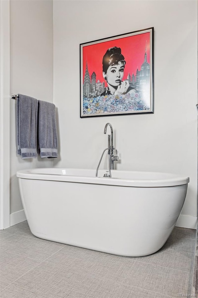 1373 S Garfield St, Denver, CO 80210 - bathroom with a freestanding bath and baseboards