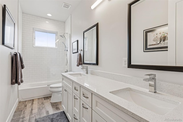 1373 S Garfield St, Denver, CO 80210 - full bath featuring toilet, wood finished floors, double vanity, shower / bathtub combination, and recessed lighting