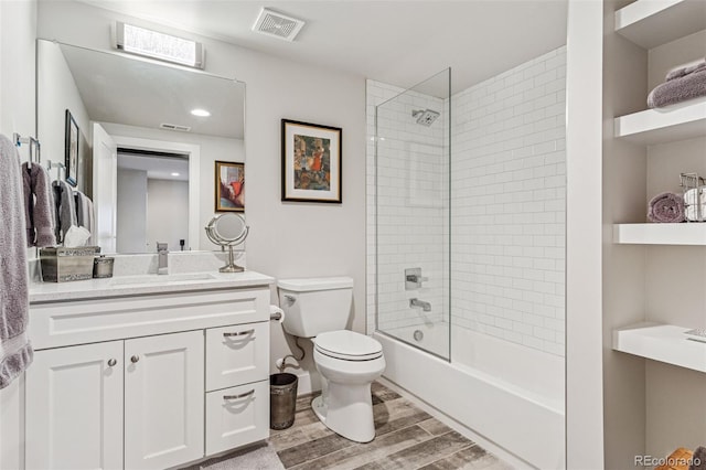 1373 S Garfield St, Denver, CO 80210 - bathroom with wood finished floors, toilet, vanity, and shower / bathtub combination