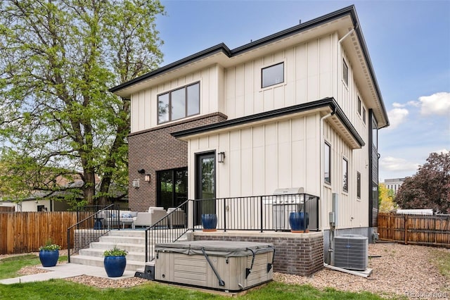 1373 S Garfield St, Denver, CO 80210 - back of house featuring central AC, a deck, a fenced backyard, and board and batten siding