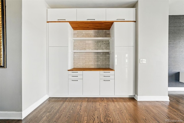 bar featuring wood finished floors and baseboards