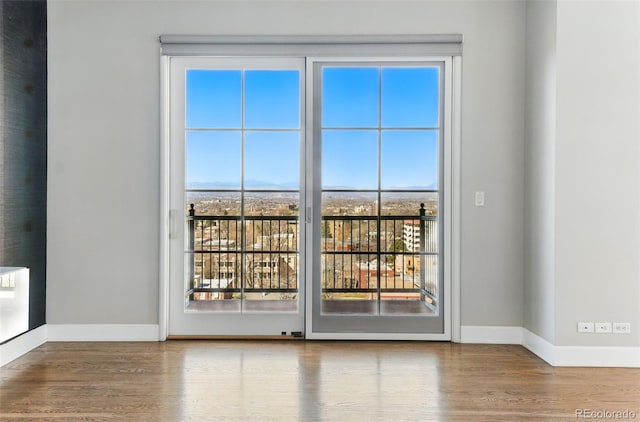 empty room with wood finished floors and baseboards