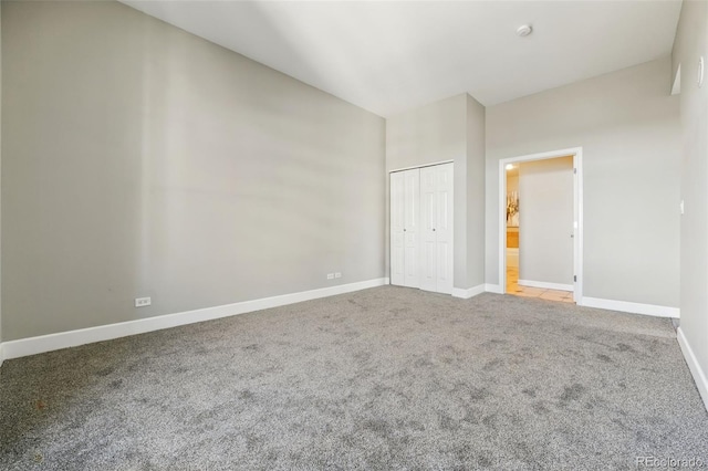 unfurnished bedroom featuring a closet, baseboards, and carpet