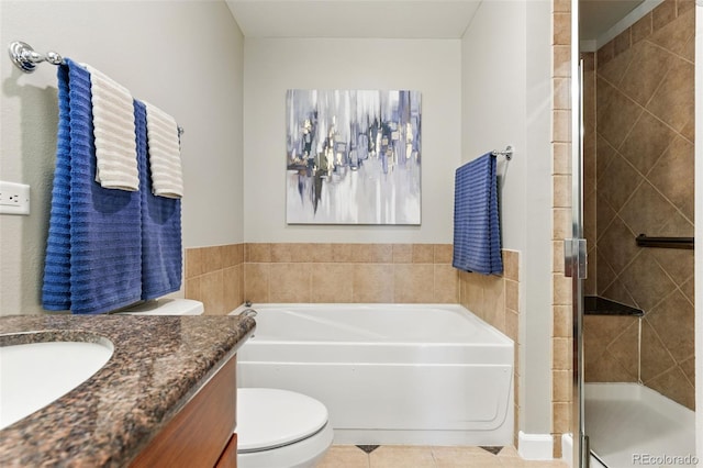 full bath with tile patterned floors, a shower stall, vanity, and a garden tub