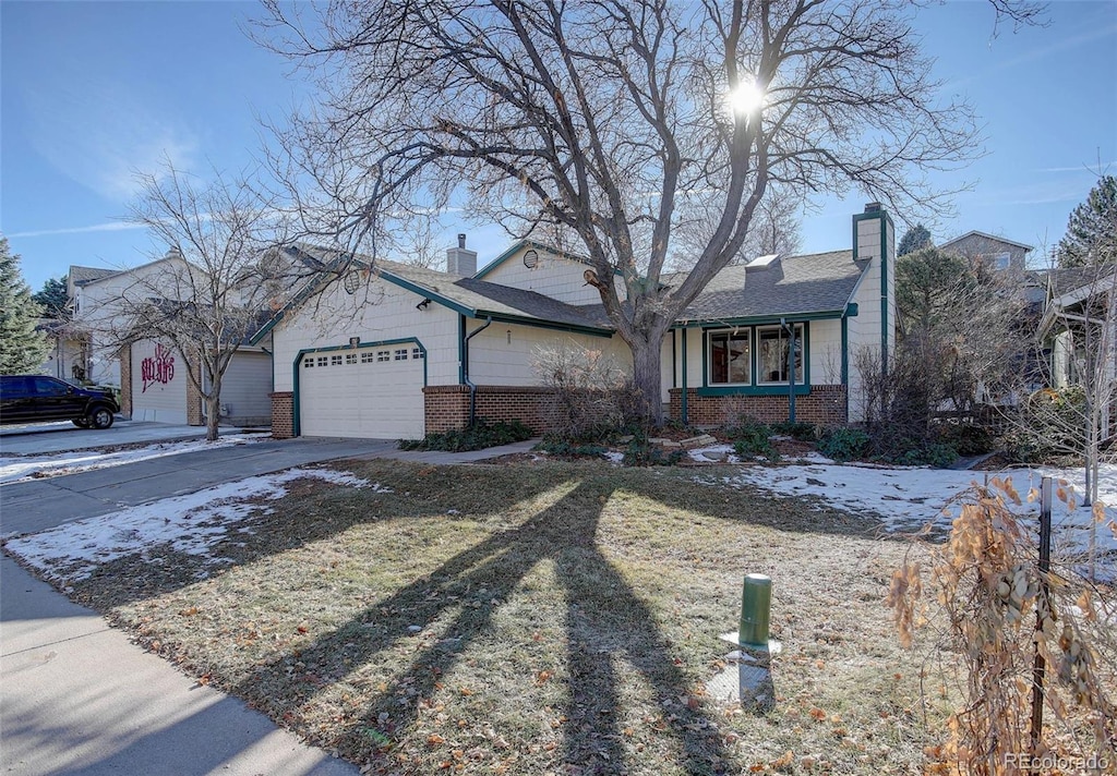 single story home featuring a garage and a front yard