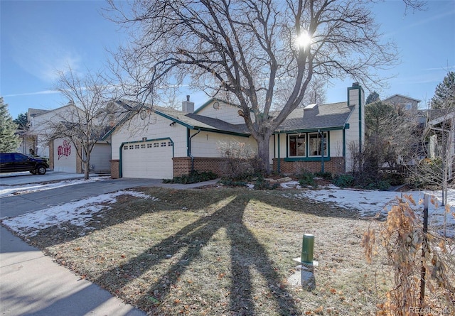 single story home featuring a garage and a front yard