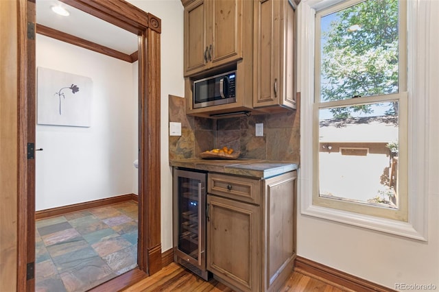 3039 W 22nd Ave, Denver, CO 80211 - kitchen with beverage cooler, decorative backsplash, and dark countertops