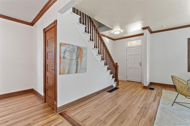 3039 W 22nd Ave, Denver, CO 80211 - entryway with light wood finished floors, crown molding, and stairs