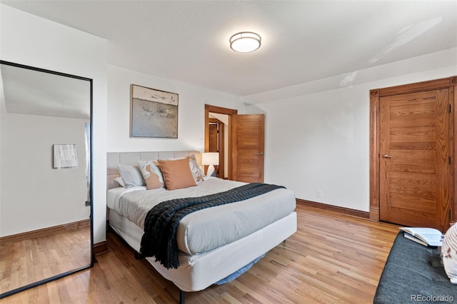 3039 W 22nd Ave, Denver, CO 80211 - bedroom featuring light wood-style flooring and baseboards