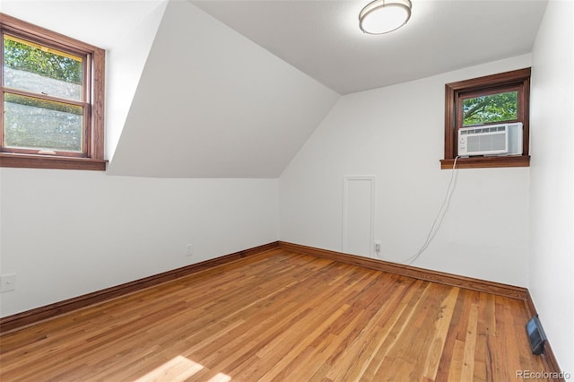 3039 W 22nd Ave, Denver, CO 80211 - additional living space with light wood finished floors, lofted ceiling, and cooling unit
