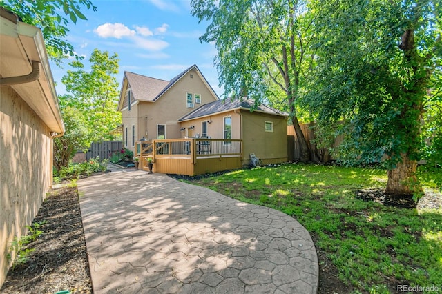 3039 W 22nd Ave, Denver, CO 80211 - rear view of property featuring stucco siding, a fenced backyard, a wooden deck, and a patio area