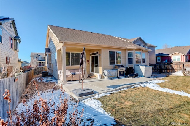 rear view of house with a patio and a lawn