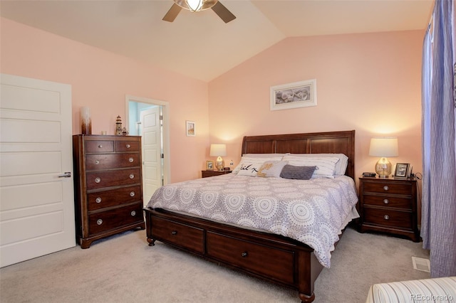 bedroom featuring ceiling fan, vaulted ceiling, and light carpet