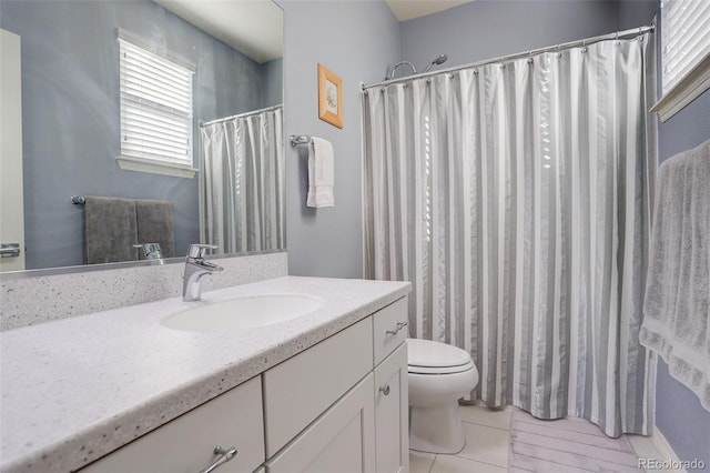 bathroom with vanity, toilet, and tile patterned flooring