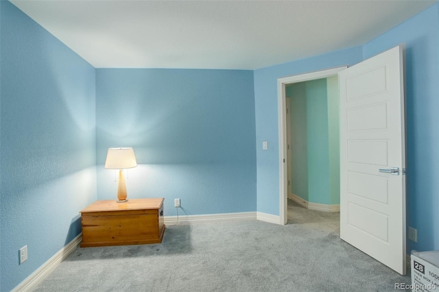 unfurnished bedroom featuring light carpet