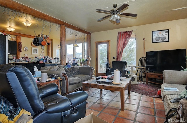 living room featuring ceiling fan, plenty of natural light, and tile patterned flooring