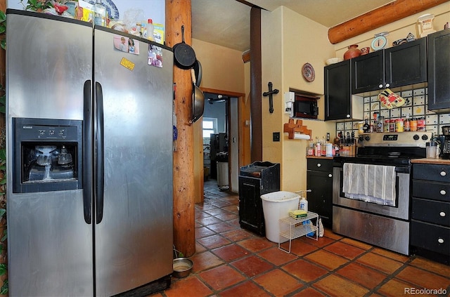 kitchen with appliances with stainless steel finishes and dark tile patterned floors