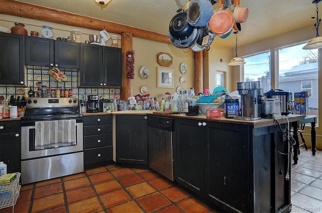 kitchen featuring tile patterned floors, kitchen peninsula, backsplash, pendant lighting, and appliances with stainless steel finishes