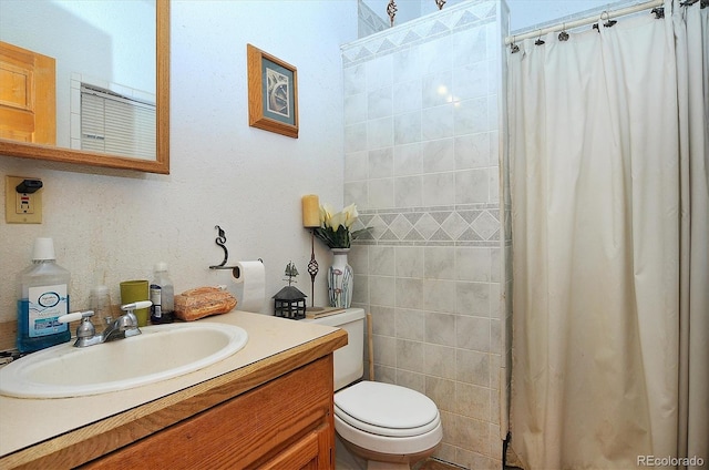 bathroom featuring walk in shower, vanity, and toilet