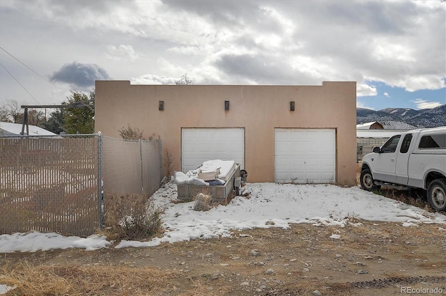 snow covered garage with a mountain view