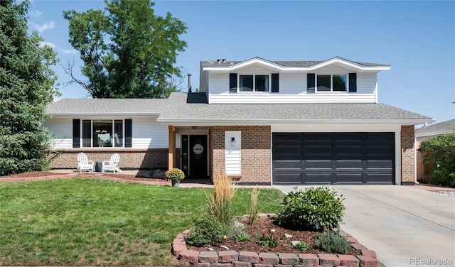 split level home featuring a front yard and a garage