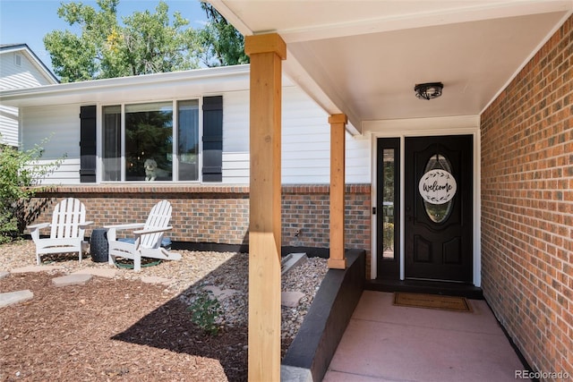 view of exterior entry featuring a porch