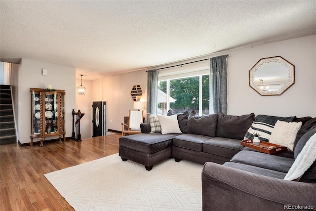 living room featuring a textured ceiling and hardwood / wood-style flooring