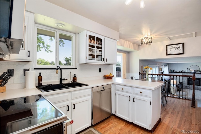 kitchen featuring stainless steel dishwasher, stove, and white cabinetry