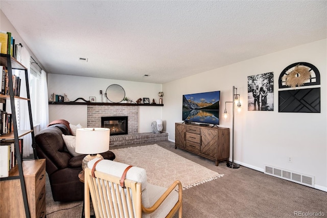 carpeted living room featuring a textured ceiling and a fireplace