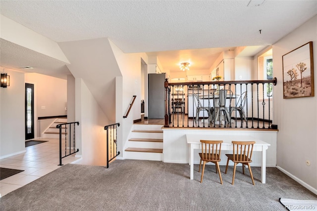 kitchen with a textured ceiling and light tile patterned floors