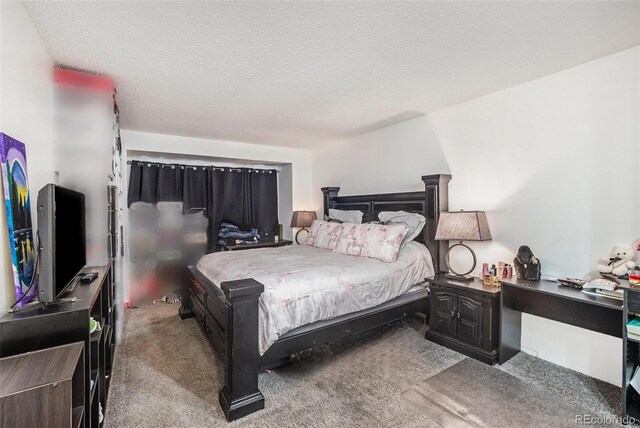 carpeted bedroom with a textured ceiling