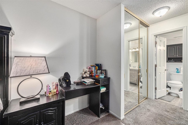 carpeted home office with a textured ceiling