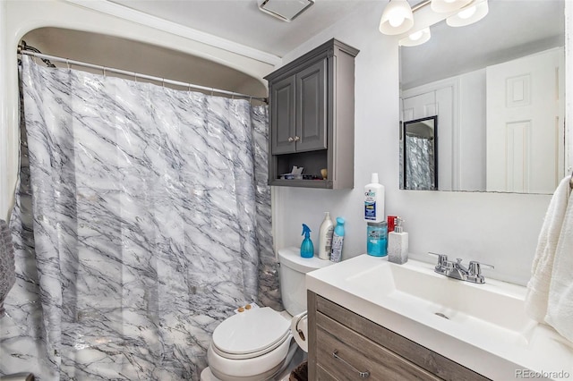 bathroom featuring a shower with curtain, toilet, and vanity