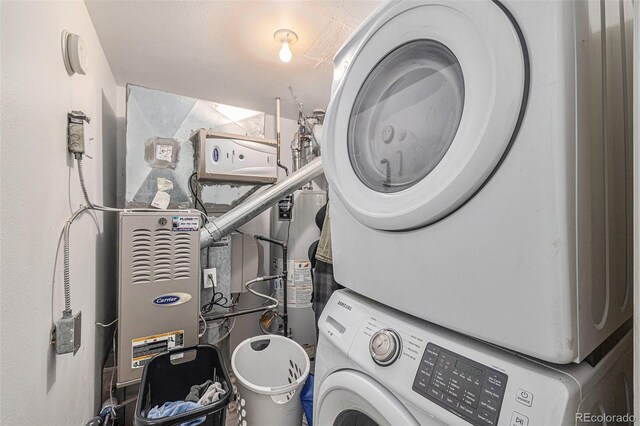 laundry room with stacked washer / dryer