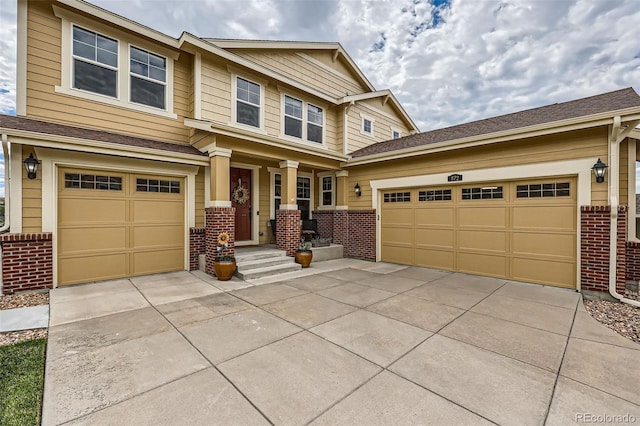 view of front of home featuring driveway and brick siding