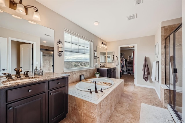 bathroom featuring tile patterned floors, independent shower and bath, and vanity