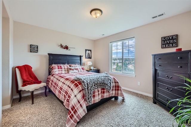 bedroom with light colored carpet, visible vents, and baseboards