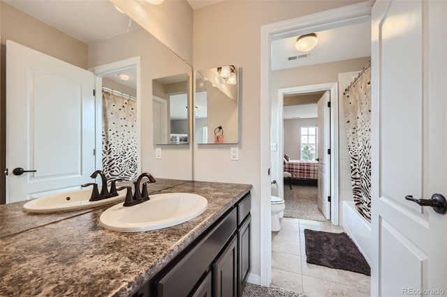 bathroom featuring tile patterned flooring, toilet, vanity, and a shower with curtain