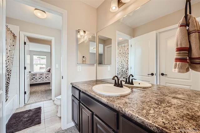 bathroom with vanity, toilet, and tile patterned floors