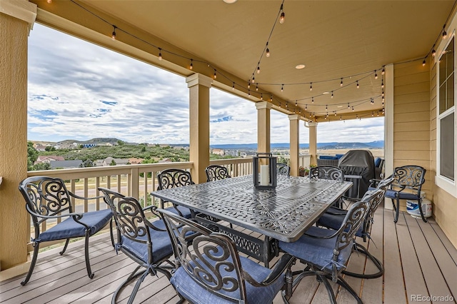 deck featuring a mountain view and outdoor dining space