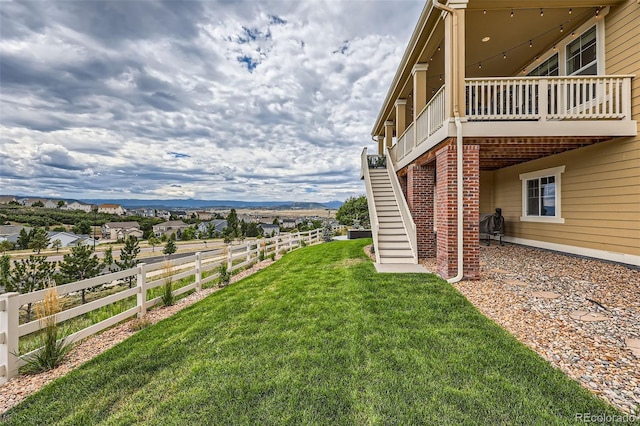 view of yard featuring stairs and fence